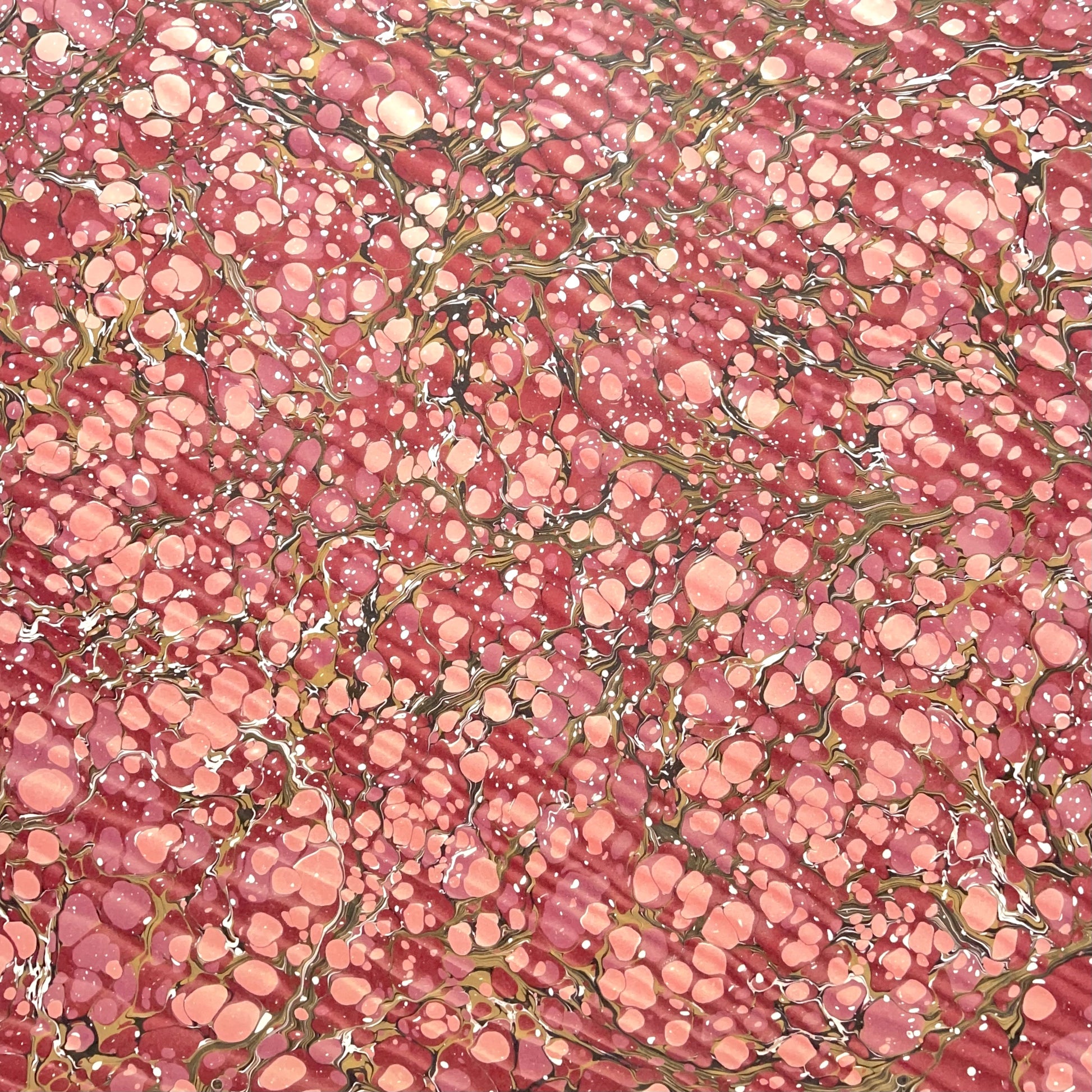 Printed marbled wrapping paper by Jemma Lewis Marbling. Marbled paper in deep burgundy, pinks and brown