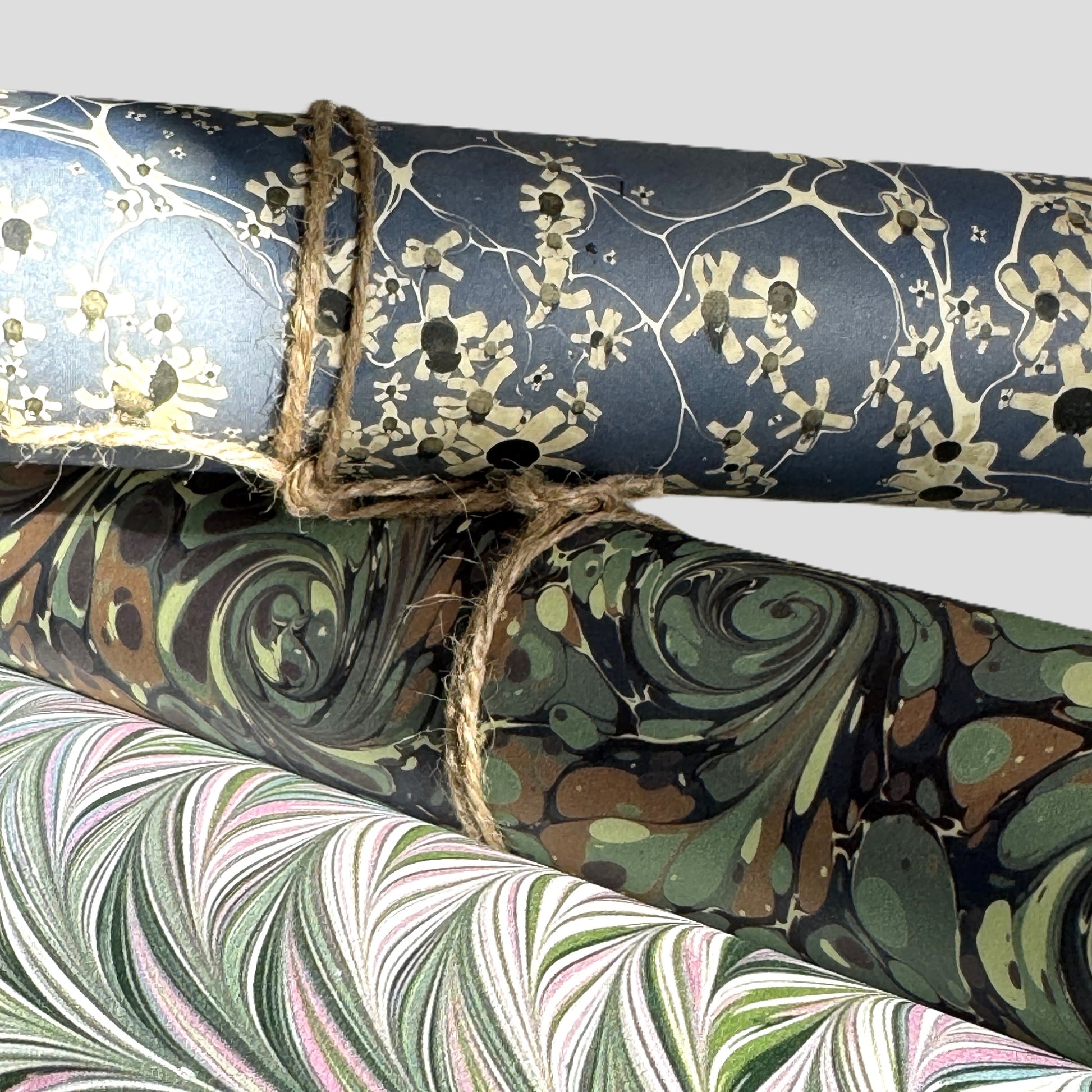 printed marble design wrapping paper by Jemma Lewis.  Daisy flower design in white and black on blue backdrop