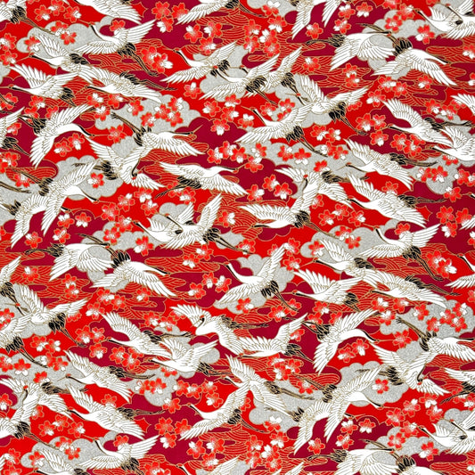 Japanese silkscreen chiyogami paper with a repeat pattern of white cranes in flight on a red and silver background