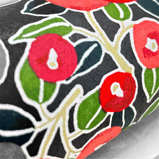 japanese silk-screen handmade paper, chiyogami, with a design showing red and pink morning glory flowers and green leaves on black background