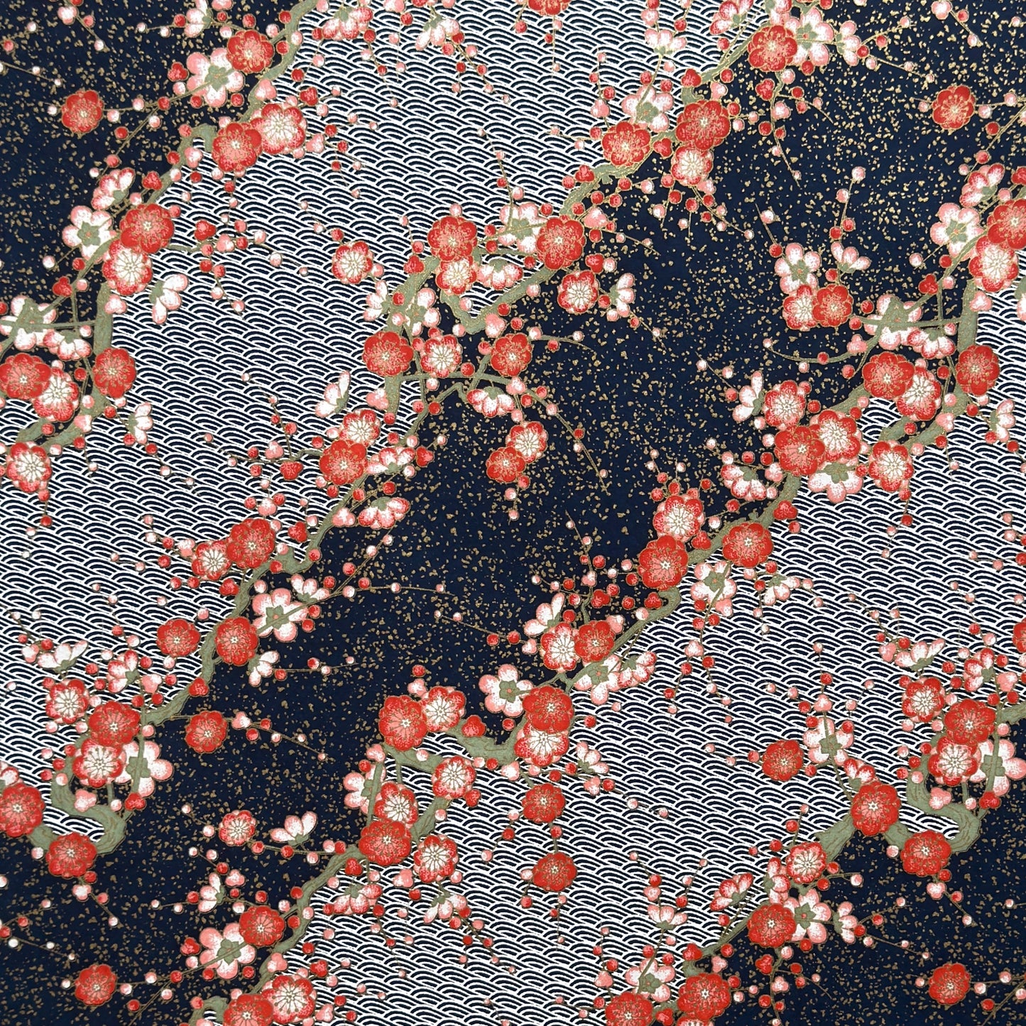 Diagonal branches of rich pink plum (ume) blossom on a midnight blue background with gold accents. Japanese chiyogami paper