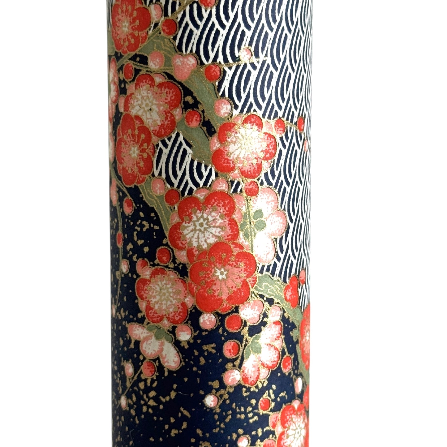 Diagonal branches of rich pink plum (ume) blossom on a midnight blue background with gold accents. Japanese chiyogami paper