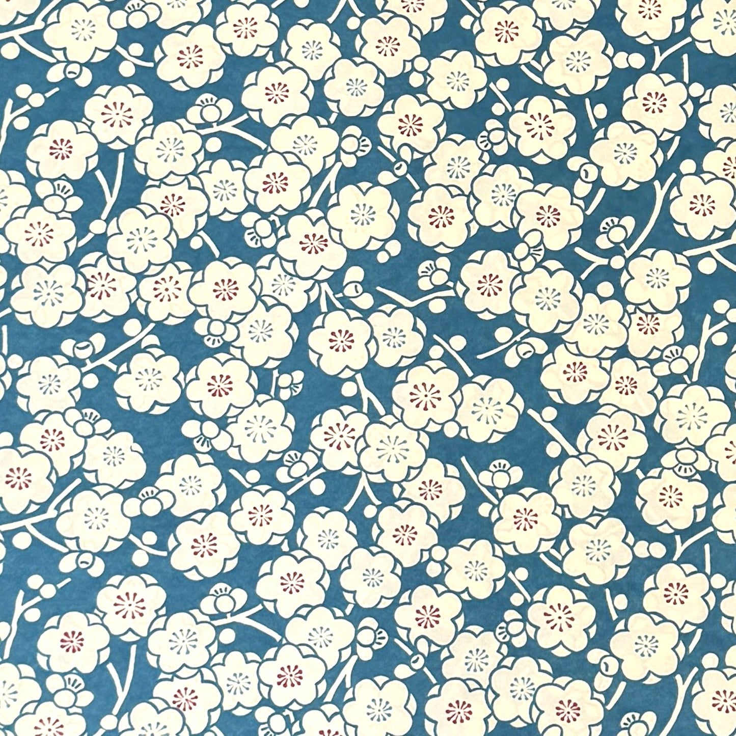 a sheet of chiyogami paper with a modern plum blossom pattern in aqua and cream