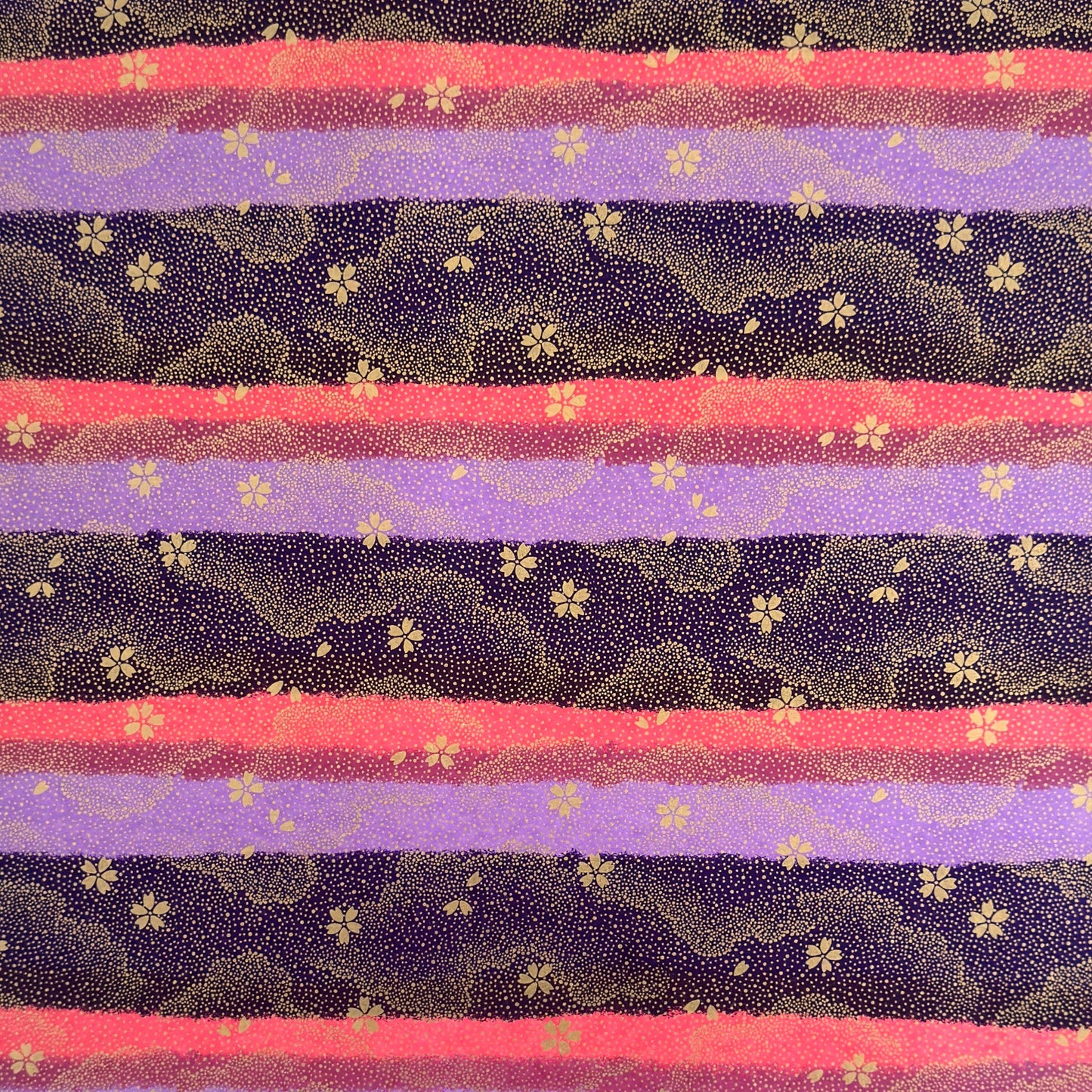 japanese chiyogami paper in stripes of pink, lilac and purple with gold clouds and flowers