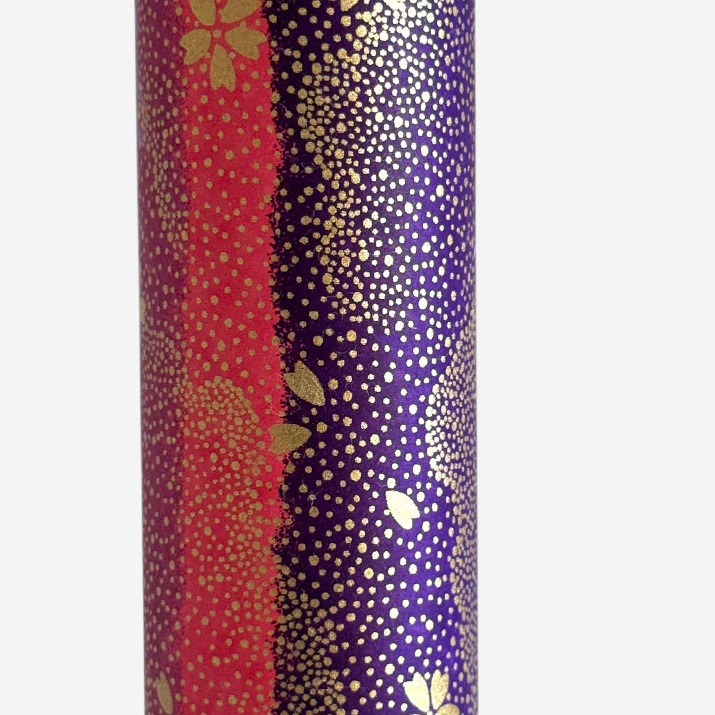 japanese chiyogami paper in stripes of pink, lilac and purple with gold clouds and flowers. Close up