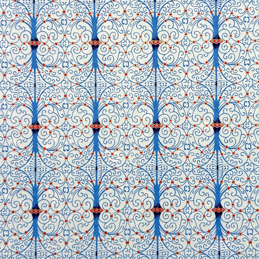 Japanese silkscreen chiyogami paper with a intricate filigree trellis design in blue with red and gold accent