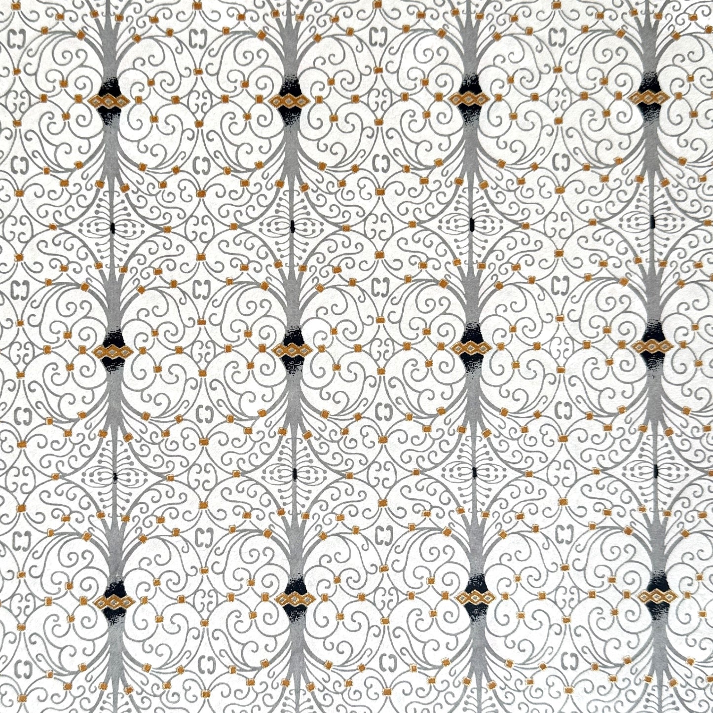 Japanese silkscreen chiyogami paper with a intricate filigree trellis design in grey with gold accent