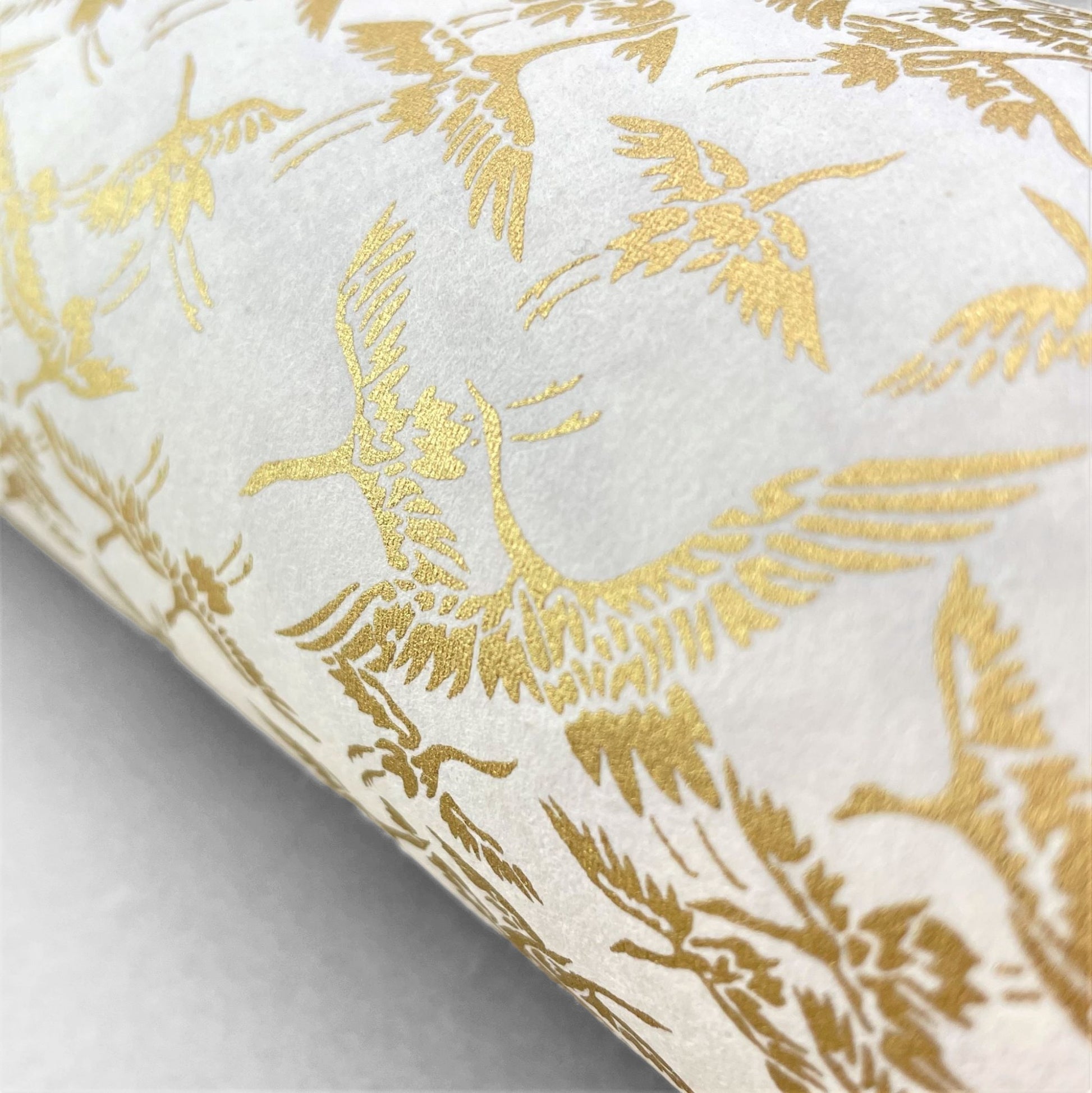 japanese silk-screen handmade paper showing gold cranes in flight on ivory backdrop