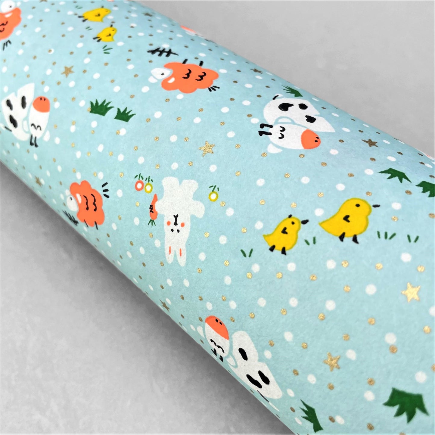 japanese silk-screen handmade paper showing spring animals motifs on a light blue backdrop