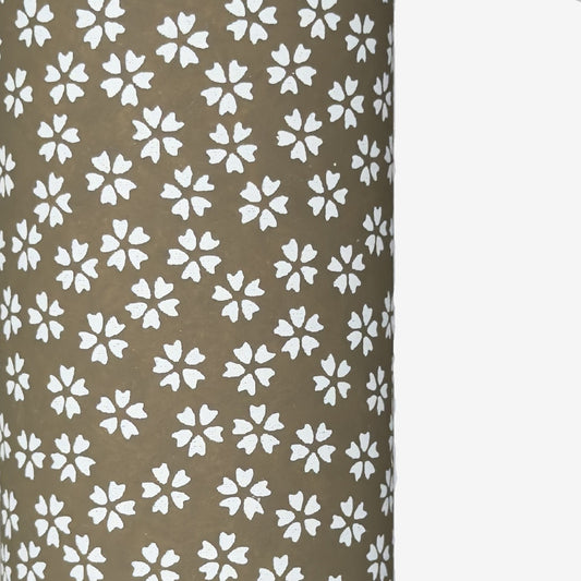 a sheet of chiyogami paper with a mocha brown background and little white stylised cherry blossom flowers