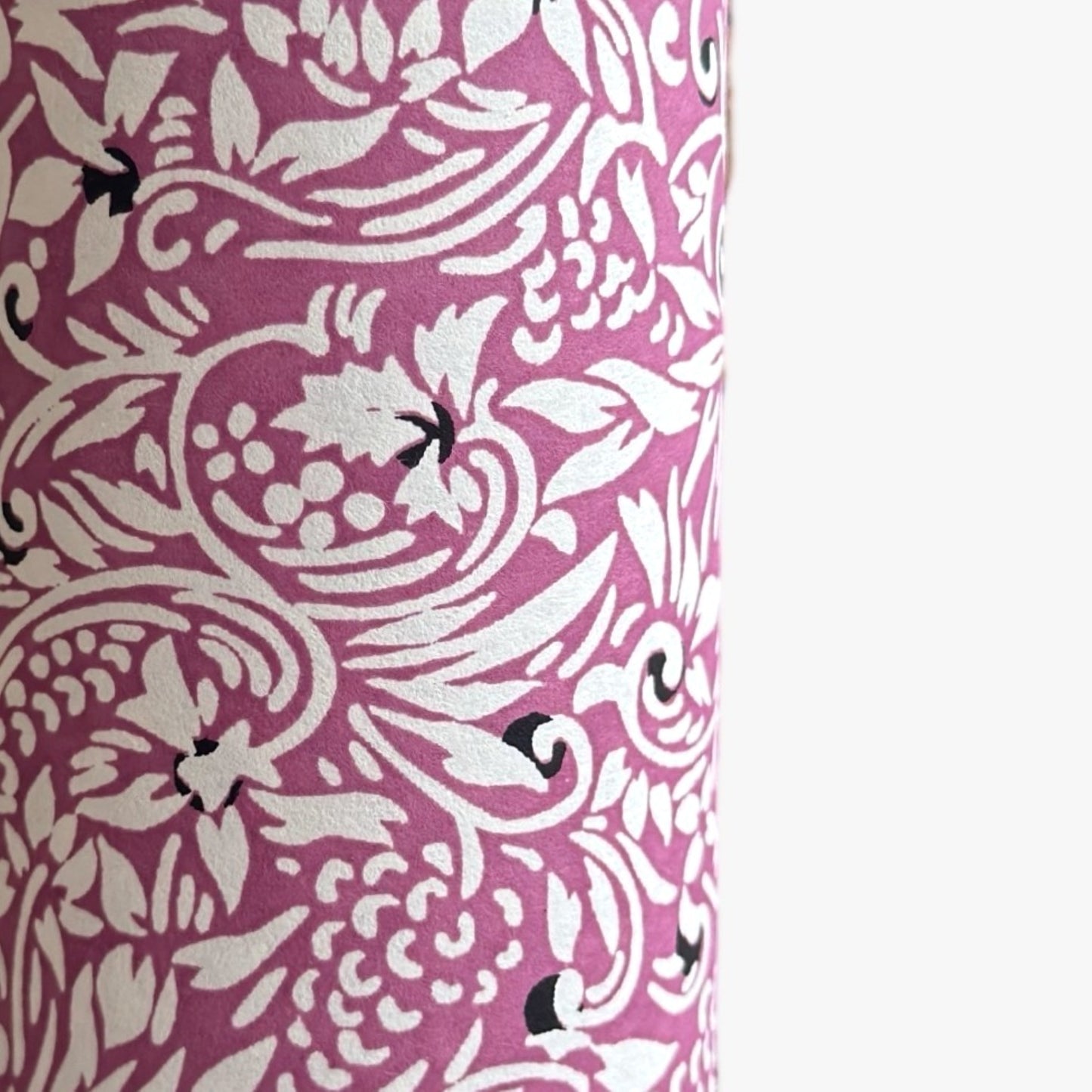 a sheet of Japanese silkscreen printed chiyogami yuzen paper with a micro floral pattern in aubergine, white and black. Close up