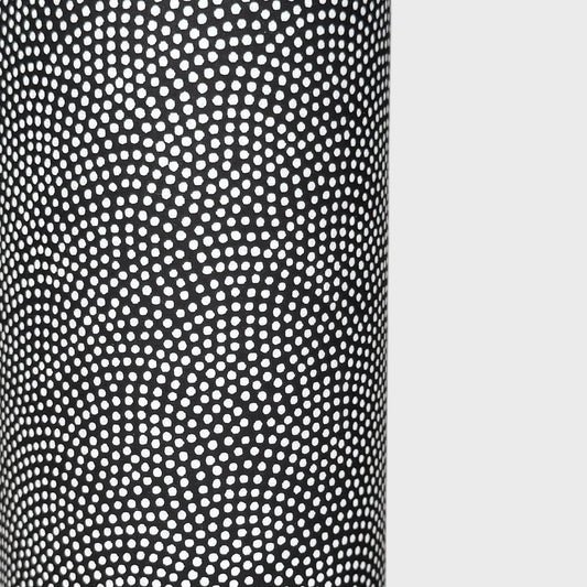 a sheet of Japanese chiyogami paper with a black background and a small pattern of white dots in repeating arch shape
