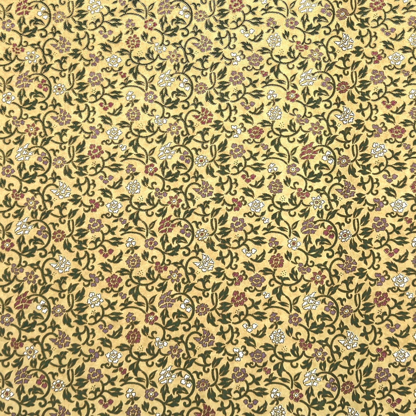 Japanese chiyogami silkscreen paper with a dainty floral pattern on a creamy backdrop and finished with gold metallic ink.