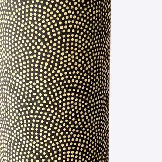 a sheet of Japanese chiyogami paper with a brown background and a small pattern of tiny cream dots in repeat arches