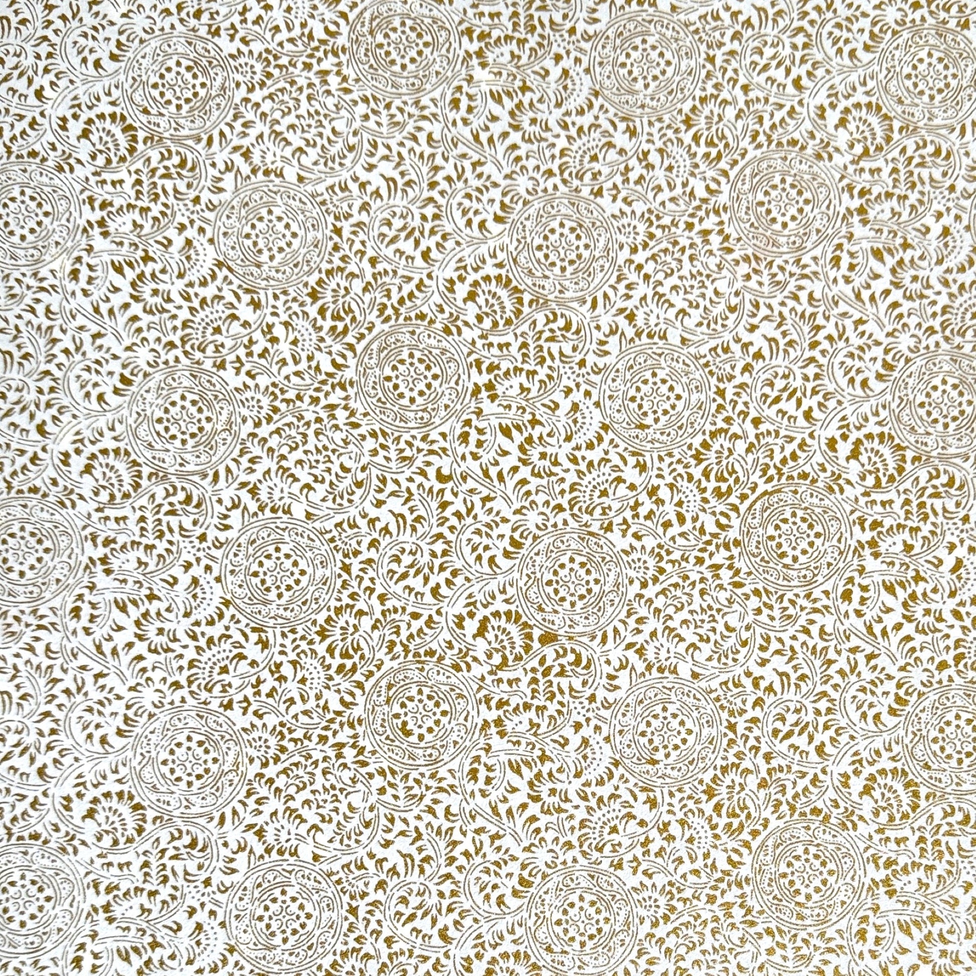 Japanese silkscreen chiyogami paper with an intricate floral pattern in gold on ivory white.