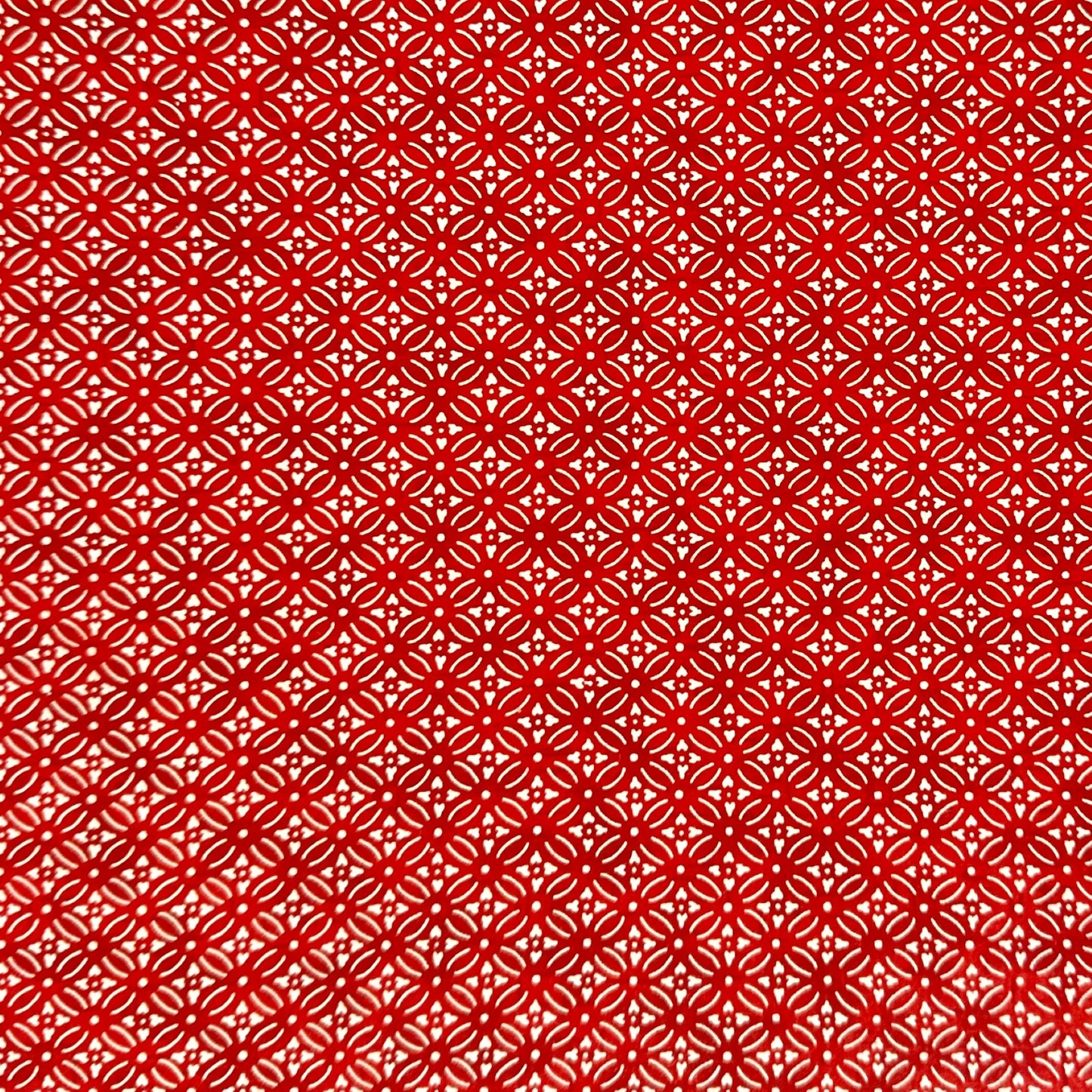 Japanese silkscreen chiyogami paper with a two-tone rich red geometric pattern on creamy white
