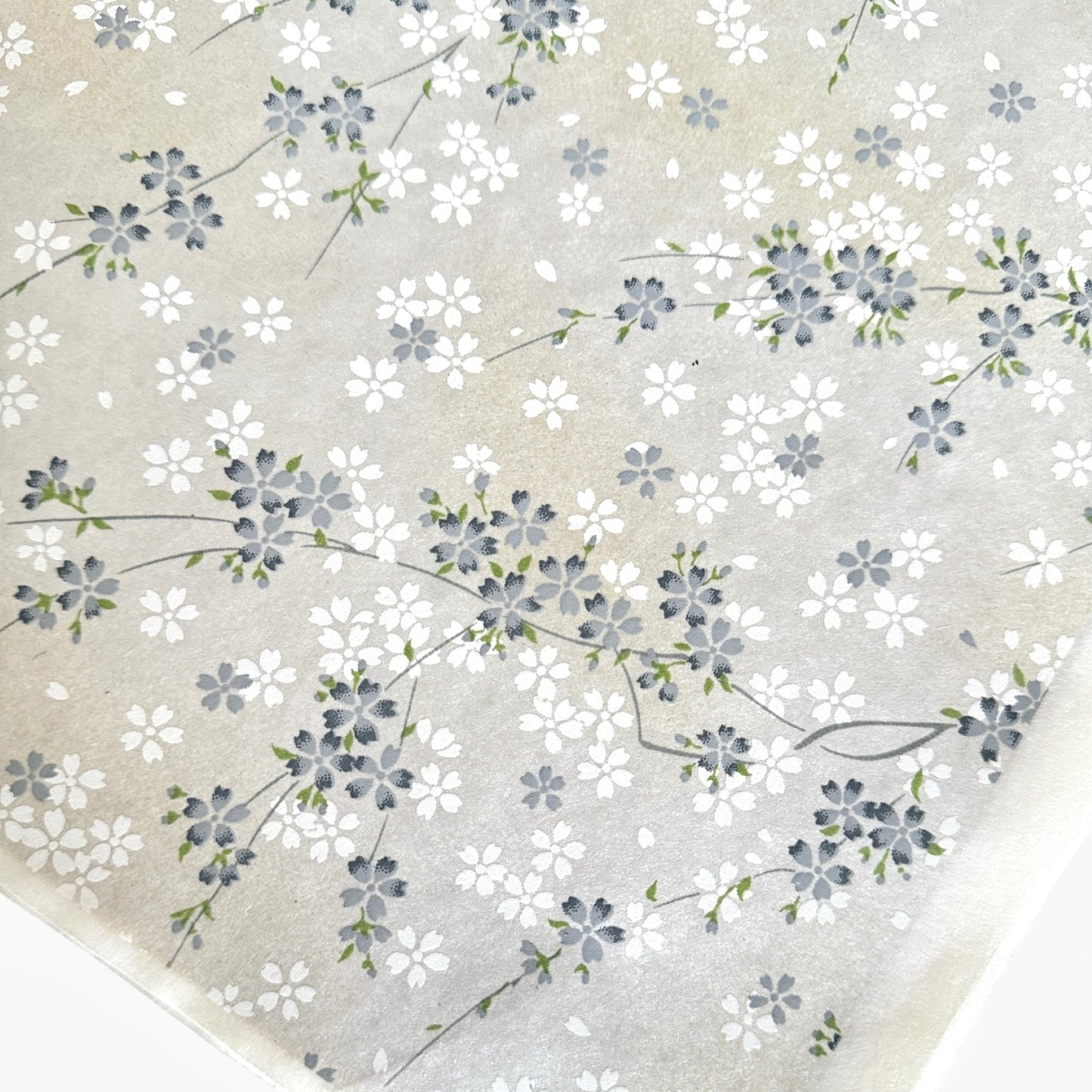 Japanese silkscreen chiyogami paper with a delicate flower design in soft grey on an ivory pearlescent backdrop