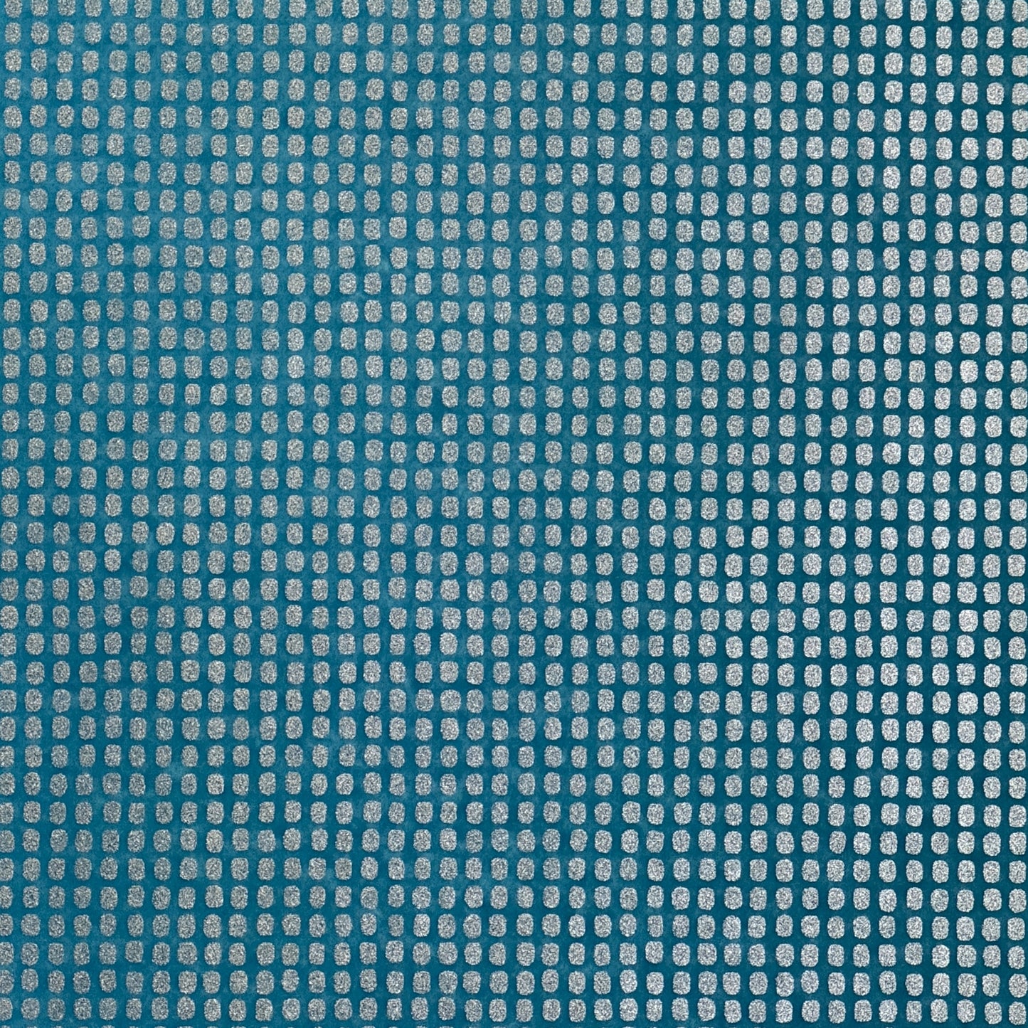 a sheet of Japanese chiyogami paper with a teal background and a repeat pattern of silver rounded rectangles