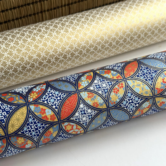 a sheet of Japanese silkscreen printed chiyogami yuzen paper with a design of overlapping circles in blue, red, yellow and white. Close up