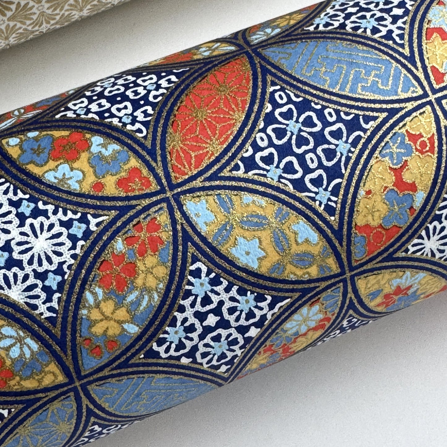 a sheet of Japanese silkscreen printed chiyogami yuzen paper with a design of overlapping circles in blue, red, yellow and white