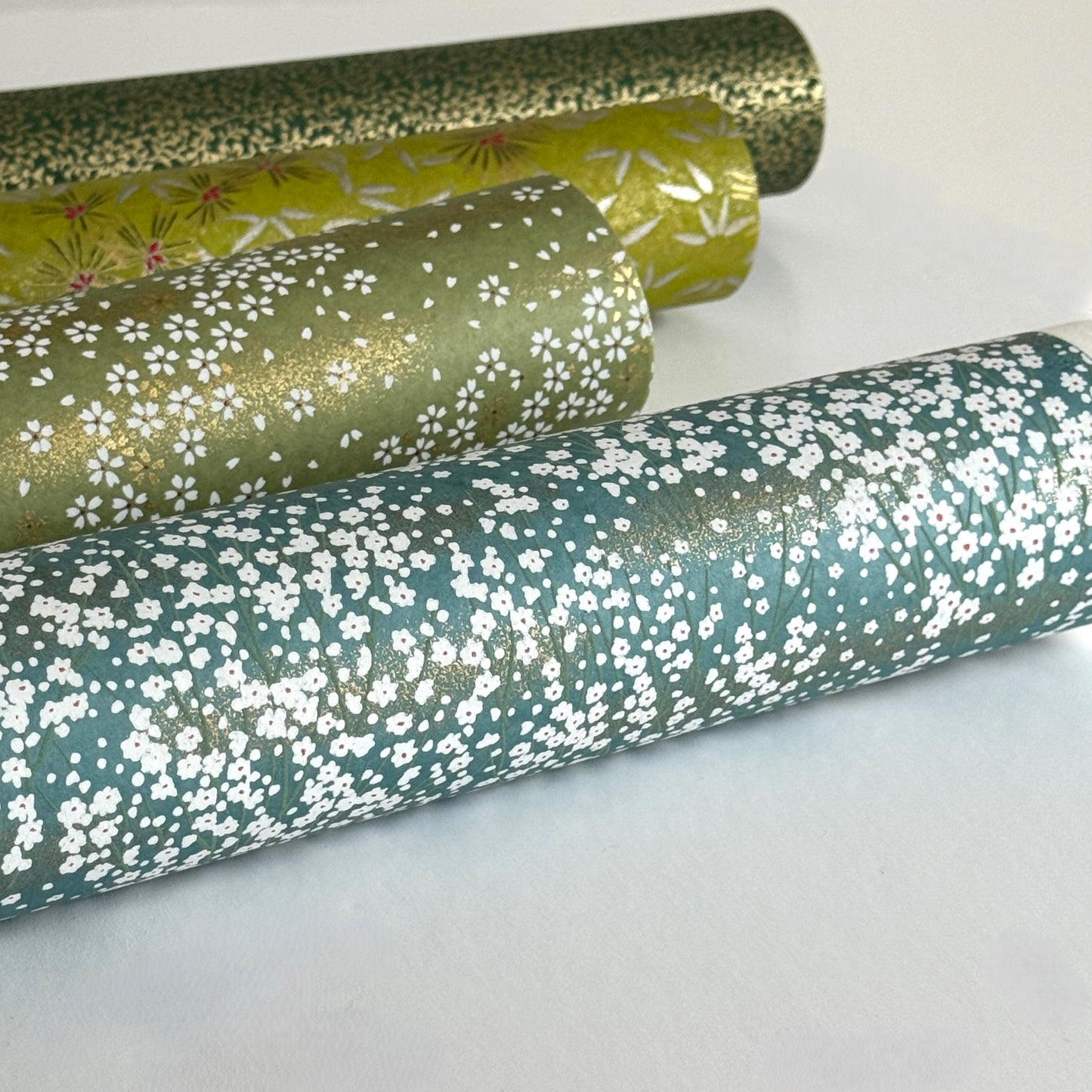 An abundance of tiny white flowers on soft teal with a dusting of gold. Japanese chiyogami paper