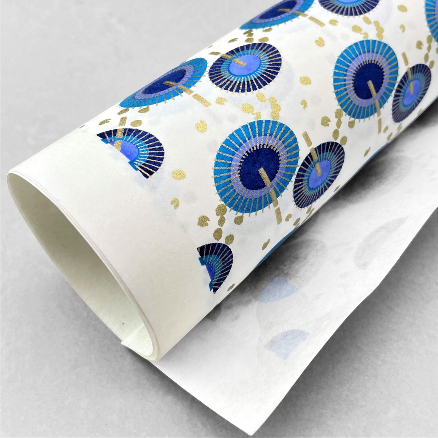 japanese silk-screen handmade paper showing a repeat pattern of blue umbrellas with gold highlights