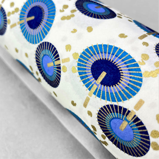 japanese silk-screen handmade paper showing a repeat pattern of blue umbrellas with gold highlights