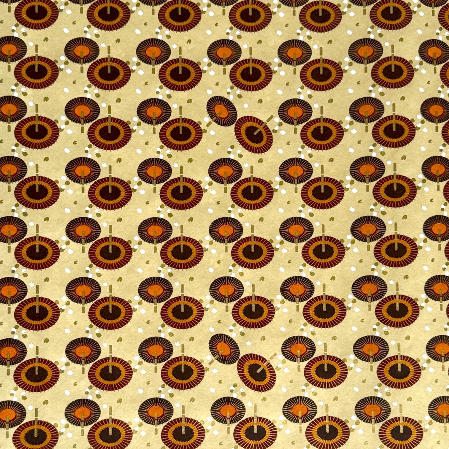 Japanese silkscreen chiyogami paper with a brown and orange umbrella pattern on a buttermilk backdrop