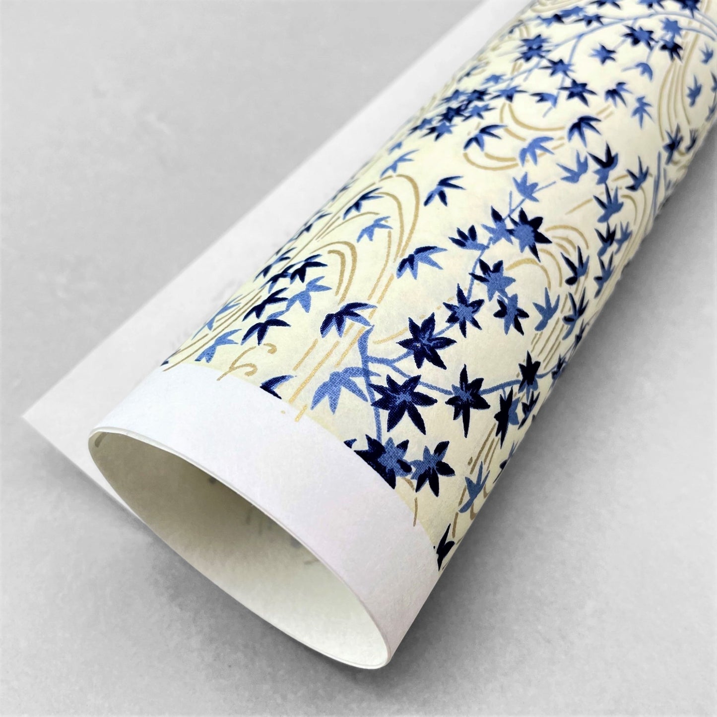 japanese silk-screen handmade paper showing gold rivers and blue falling leaves and foliage