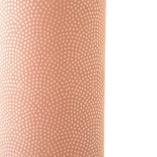 a sheet of Japanese chiyogami paper with a blush pink background and a small pattern of white dots in repeating arch shape