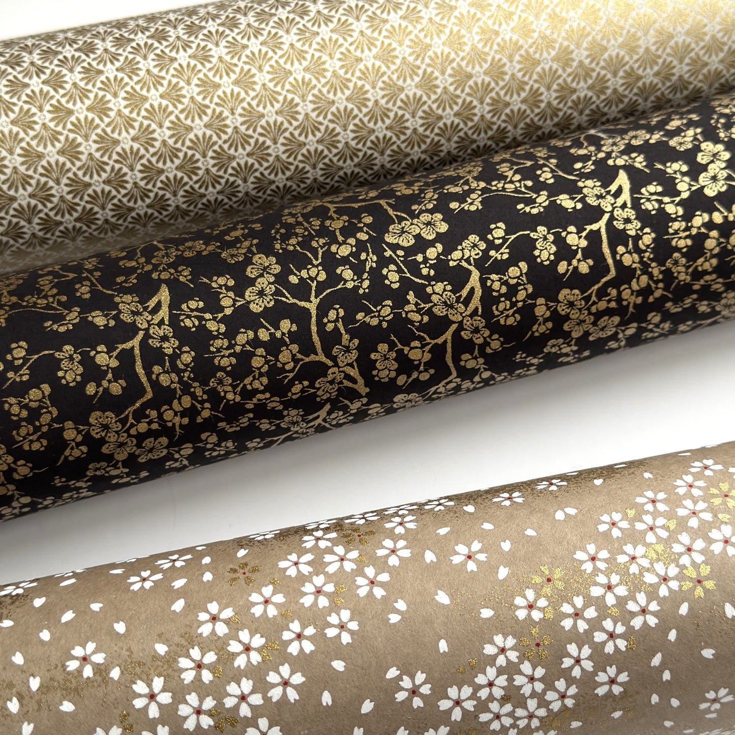 a sheet of Japanese chiyogami yuzen paper with a micro botanical pattern in gold on black