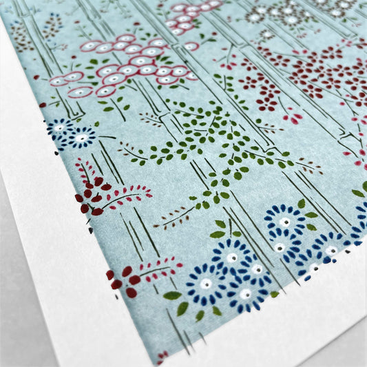 japanese silk-screen handmade paper showing pattern of bamboo, flowers and foliage on light teal backdrop