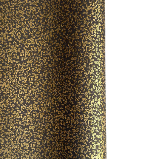 a sheet of Japanese chiyogami yuzen paper with a micro botanical pattern in gold on black