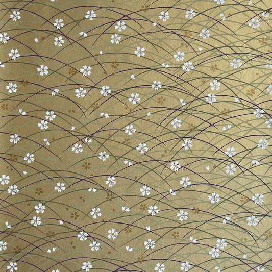 Japanese silkscreen chiyogami paper with a pattern of purple arches and white cherry blossom on antique gold backdrop