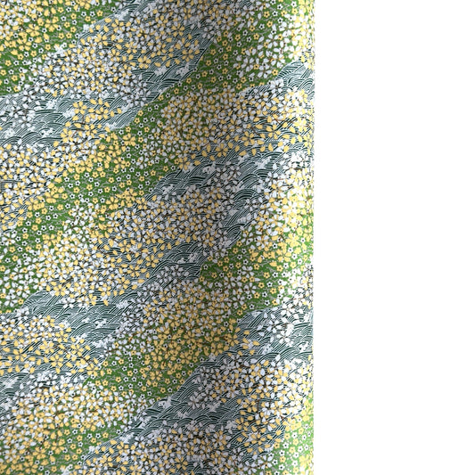 Japanese silkscreen chiyogami paper with a pattern of dark green rivers and grass green banks with an abundance of little flowers in white and yellow