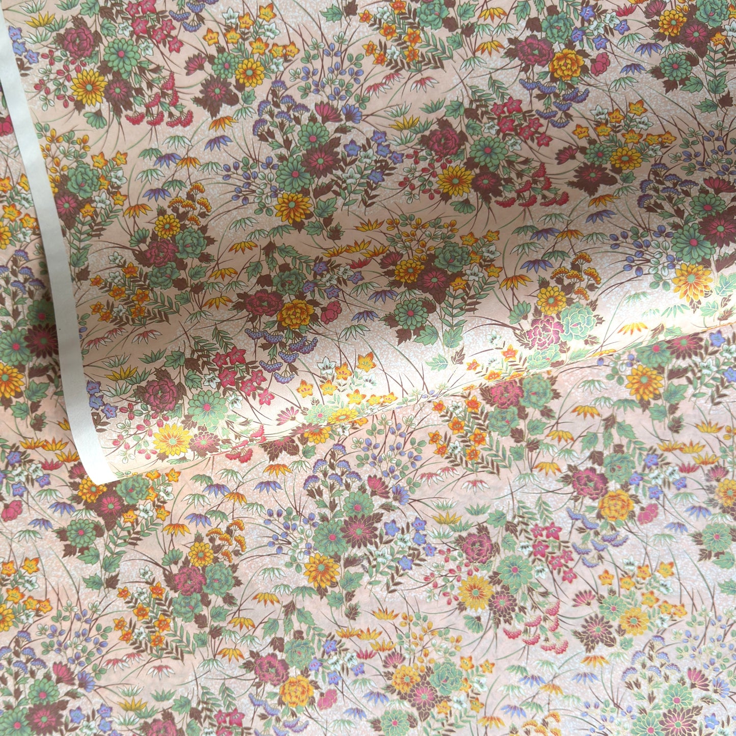 japanese silkscreen printed paper with a delicate floral bouquet design on blush pink background.