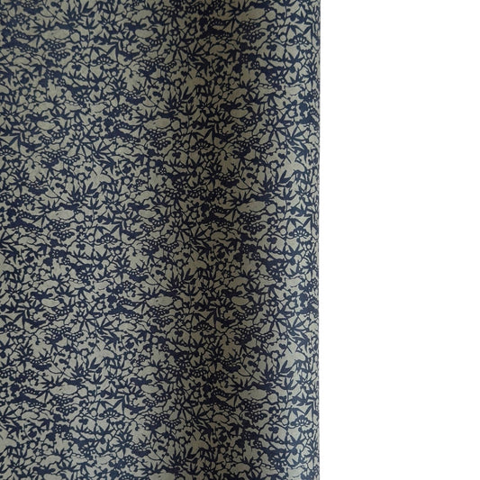 a sheet of Japanese chiyogami yuzen paper with a small abstract pattern in midnight blue on grey
