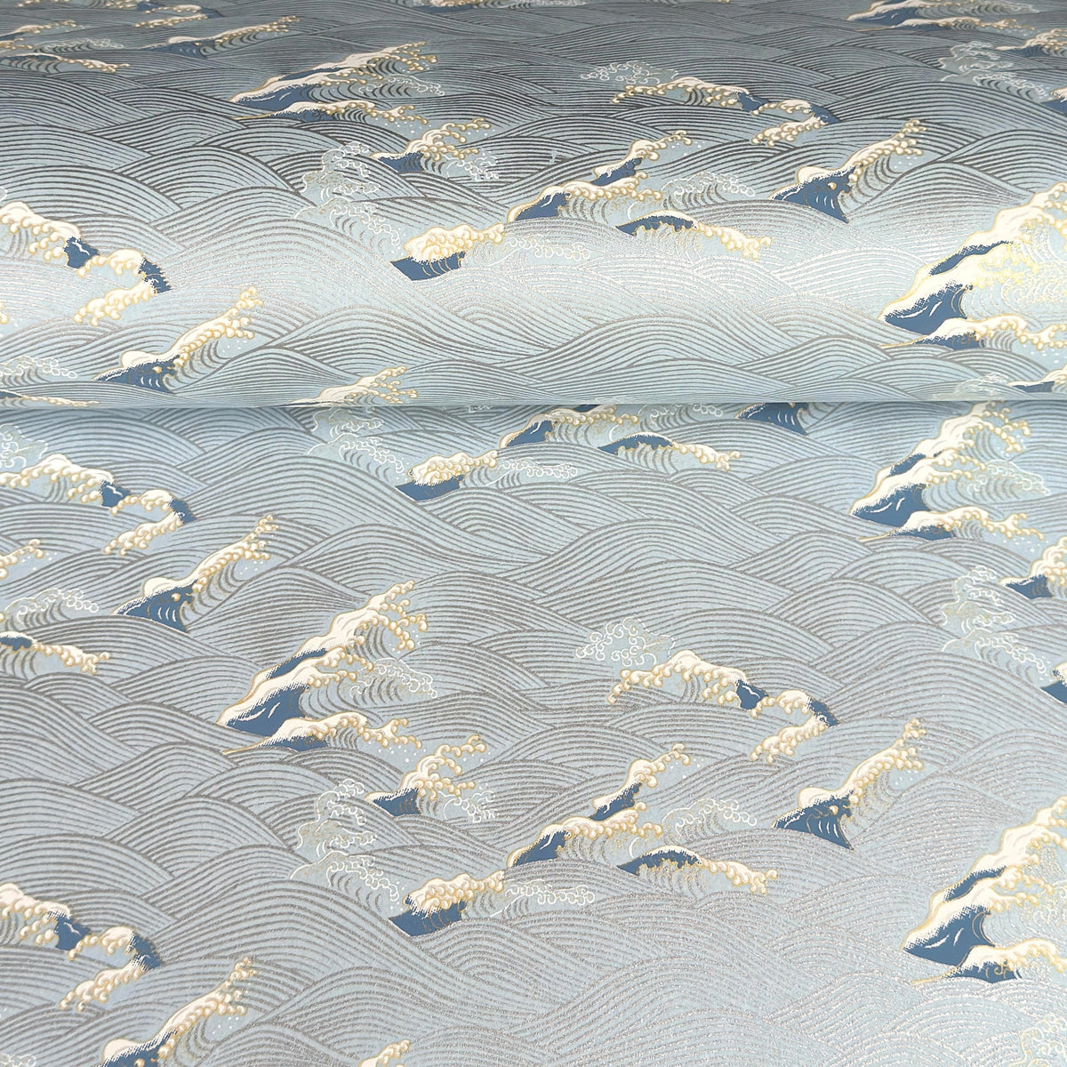 Japanese chiyogami paper with a wave pattern in pale blue, gold and silver.
