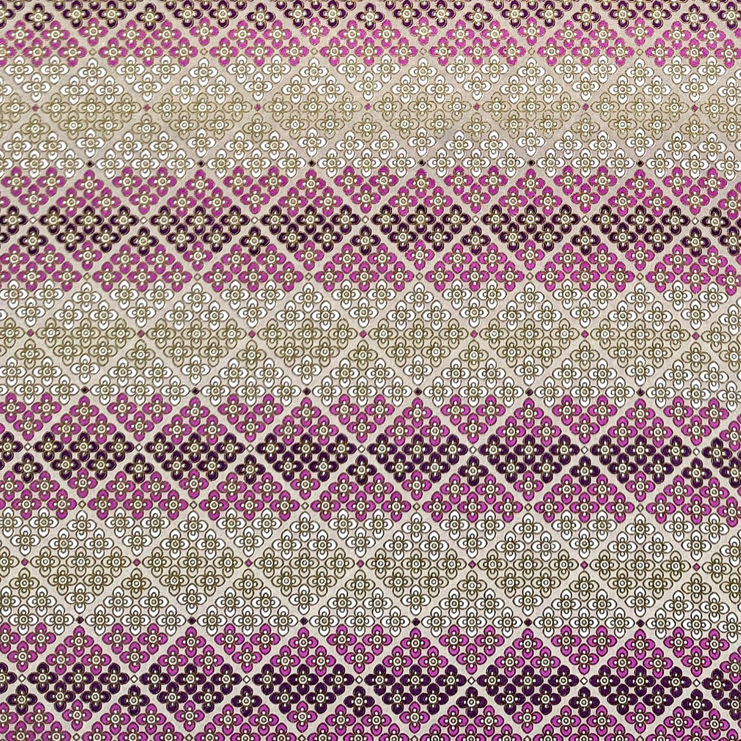 Japanese chiyogami silkscreen printed paper with rows of small flower motifs in purple, lilac and white on a taupe background with gold accents.