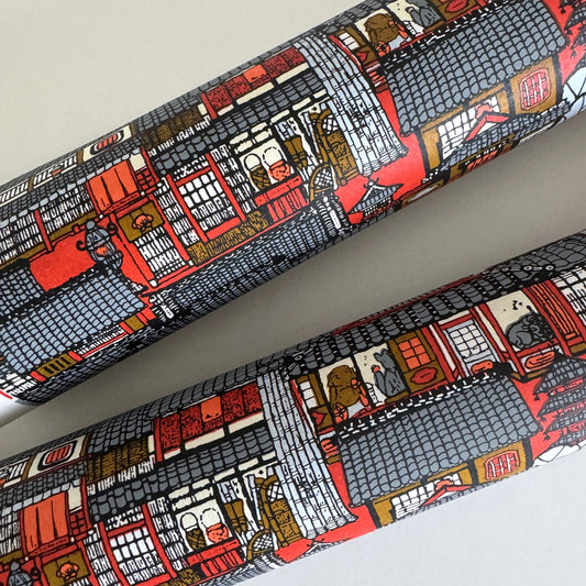 Japanese chiyogami paper (silkscreen printed) with a city landscape in grey, red and orange. Rolled
