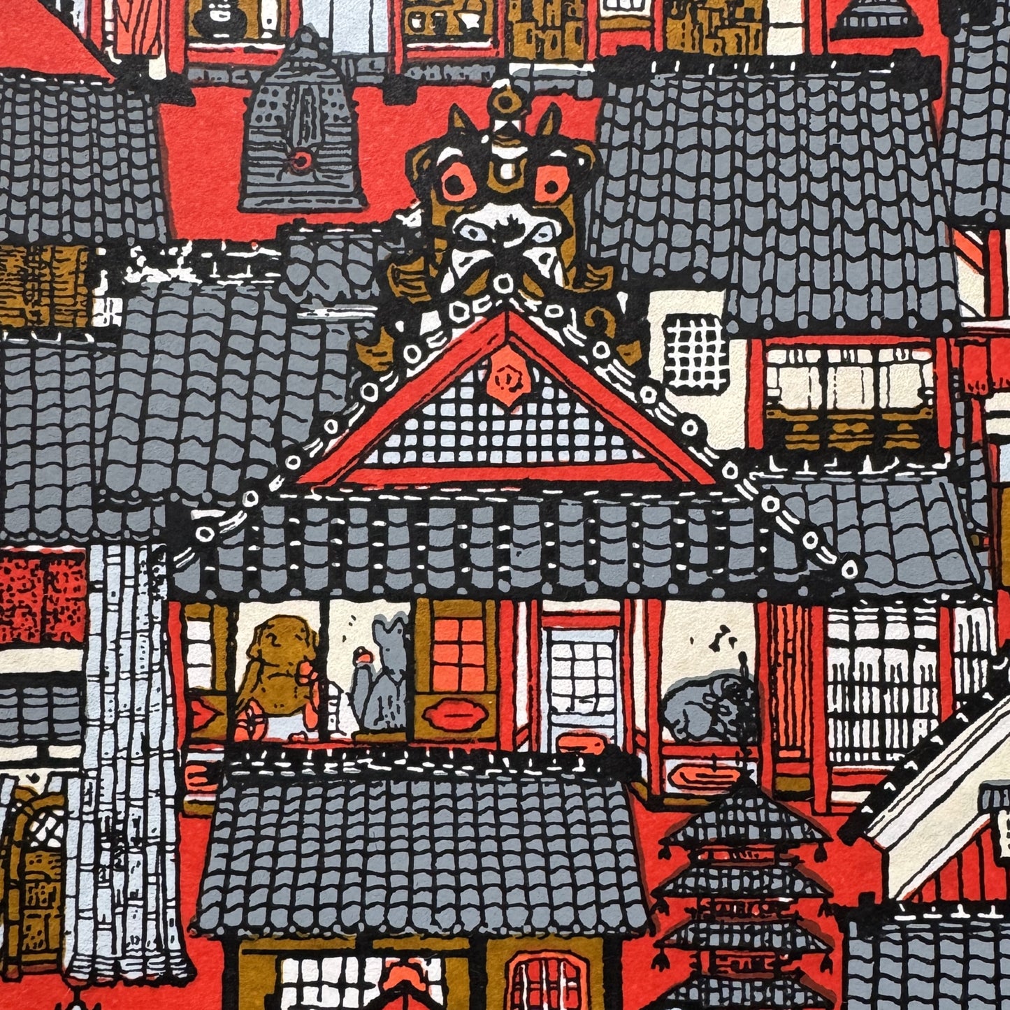Japanese chiyogami paper (silkscreen printed) with a city landscape in grey, red and orange. Close up