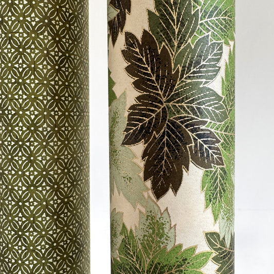 Japanese chiyogami paper with a pattern of green leaves in various tones with gold accent. close-up