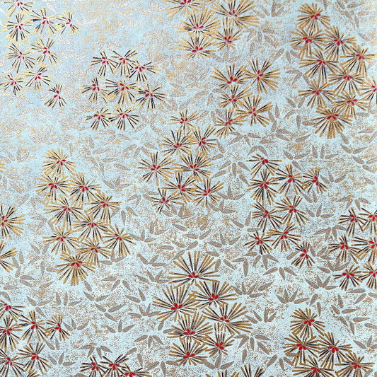 Japanese chiyogami paper silkscreen printed with gold pine needle design on a soft aqua backdrop.
