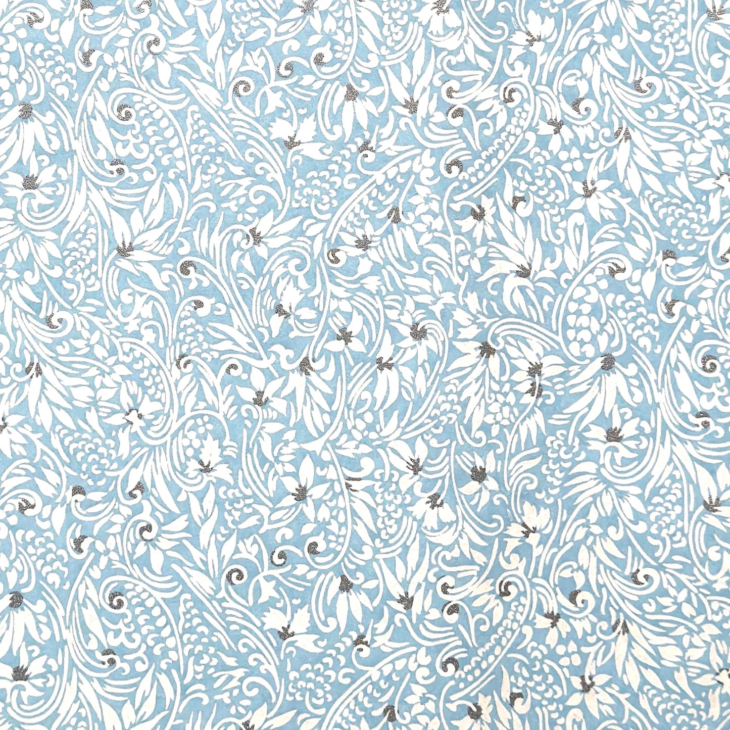 Japanese chiyogami paper - silkscreen printed - light blue backdrop with a small botanical pattern in white with silver accents.