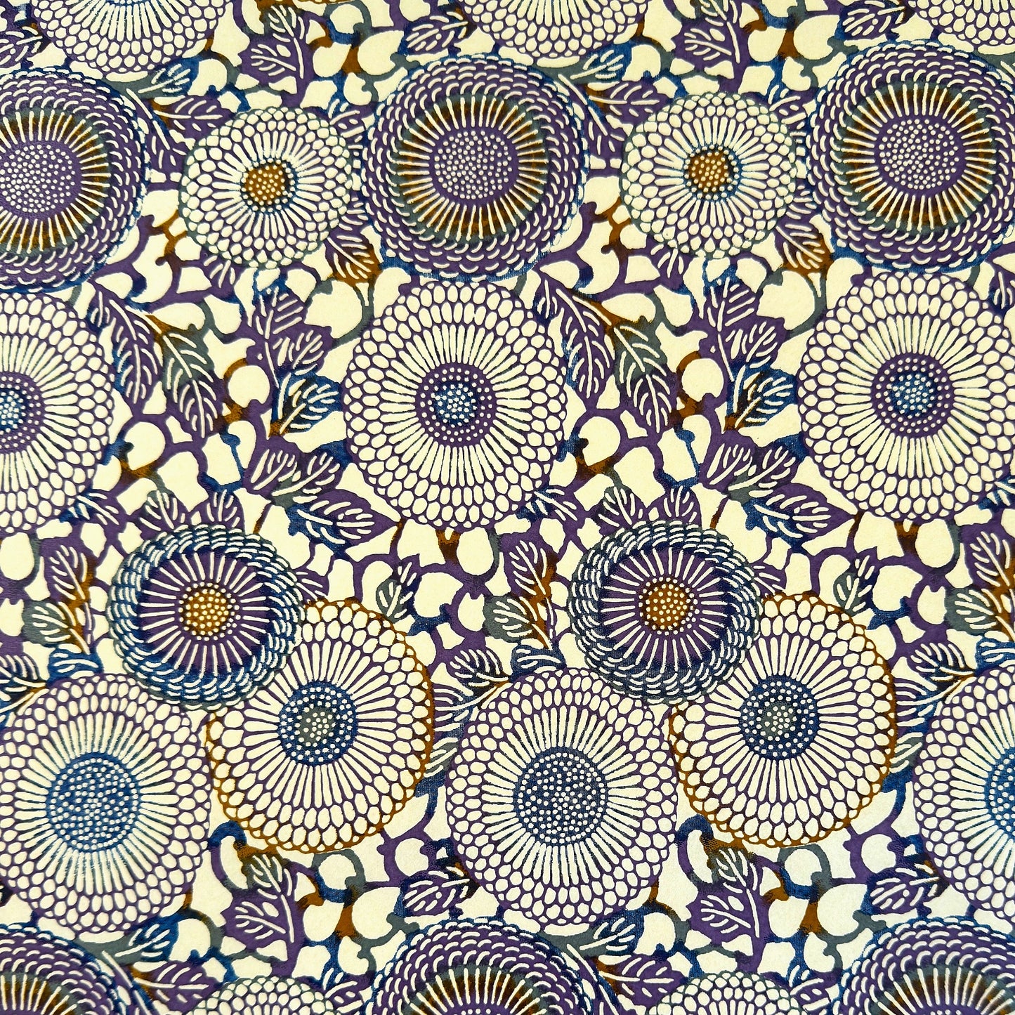 Japanese chiyogami silkscreen printed paper with a floral kiko pattern in purple and blue on a cream backdrop