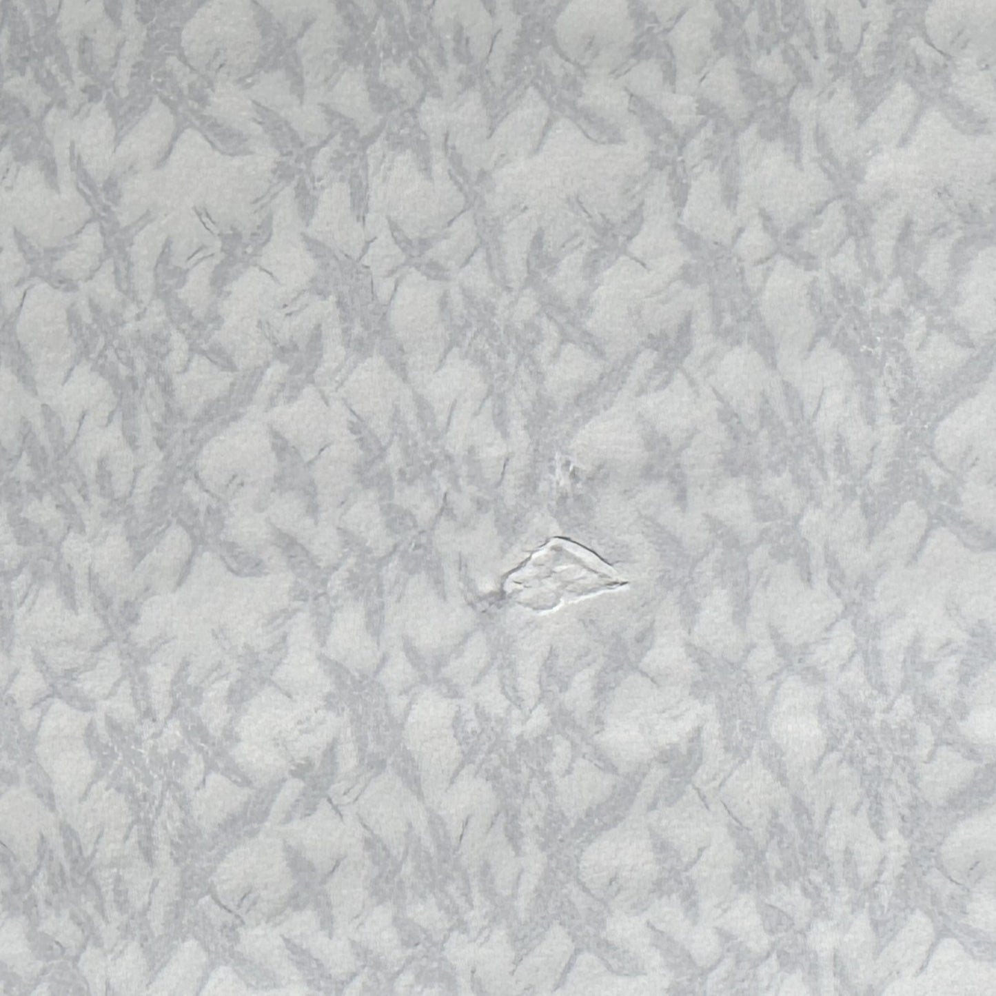 japanese silk-screen handmade paper showing gold cranes in flight on ivory backdrop, reverse of paper showing a small damage to the paper