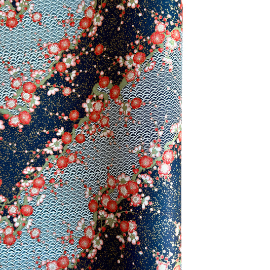 Diagonal branches of rich pink plum (ume) blossom on a midnight blue background with gold accents. Japanese chiyogami paper