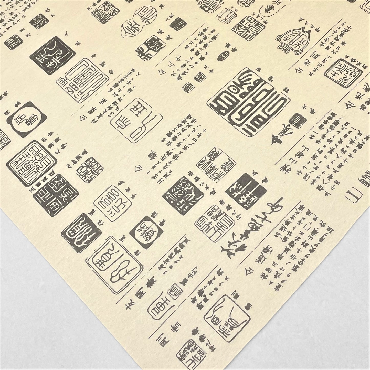 japanese tissue paper with cream backdrop and black Japanese "chops" , signature stamps