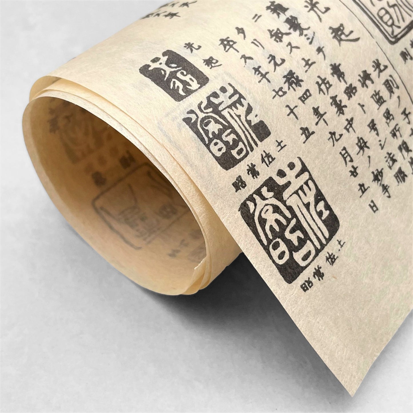 japanese tissue paper with cream backdrop and black Japanese "chops" , signature stamps