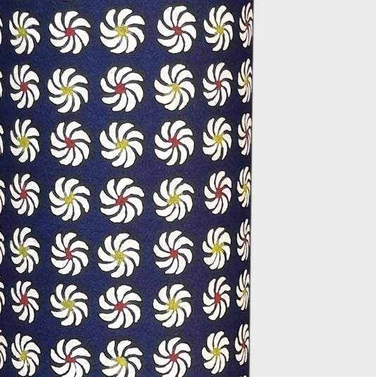 Small pattern with abstract circular flowers in white, red and yellow on a dark blue background. A sheet of katazome paper. Close up